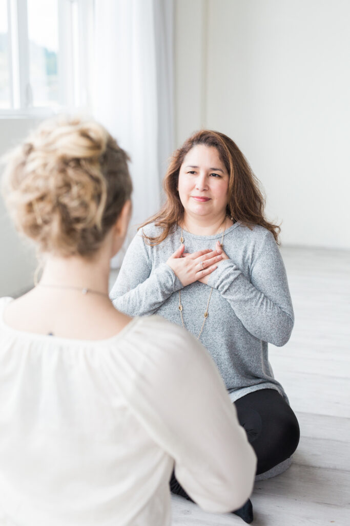 woman with her hands on her heart