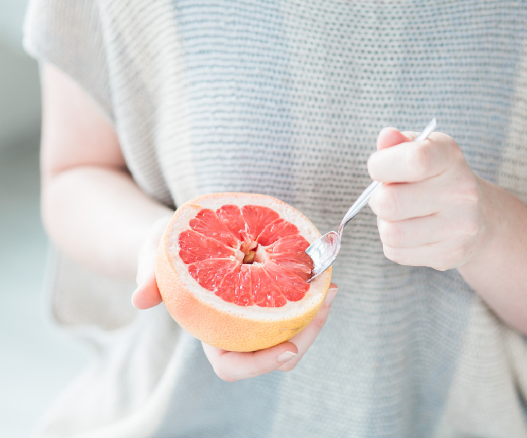 woman eating grapefruit