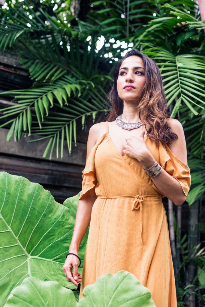 woman in orange dress with hand on heart