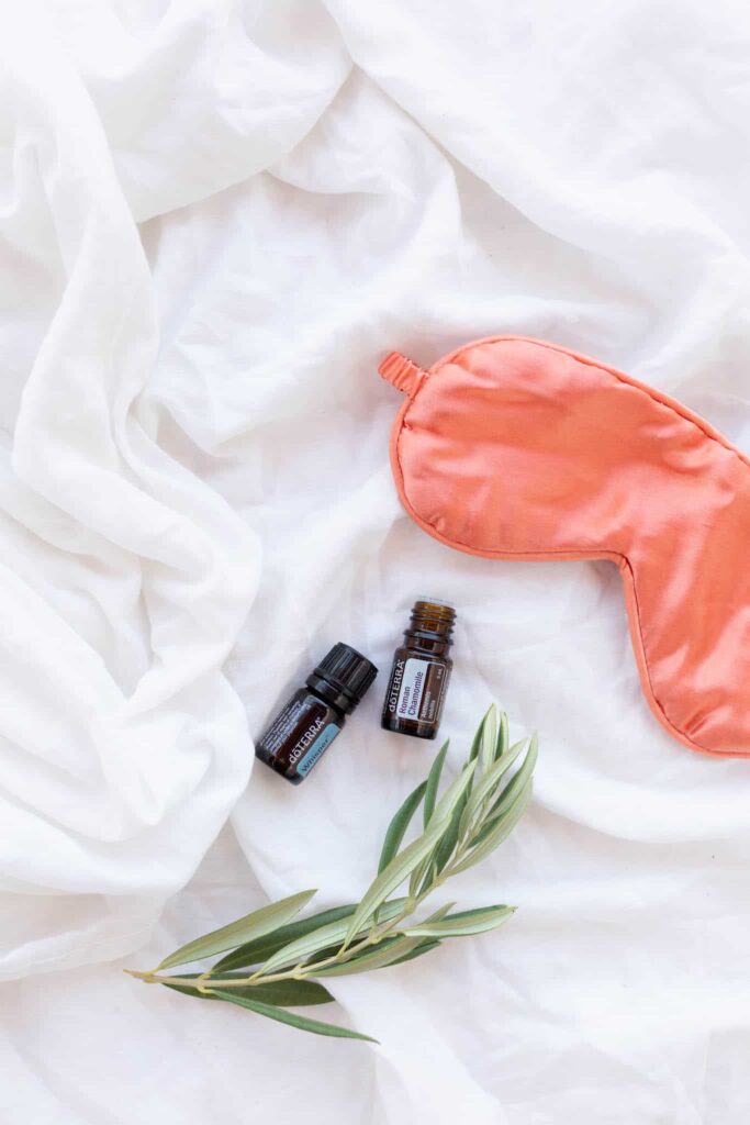 essential oils with a pink eye mask