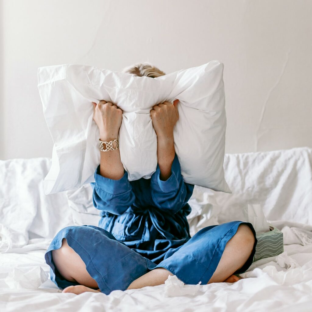 woman screaming into a pillow