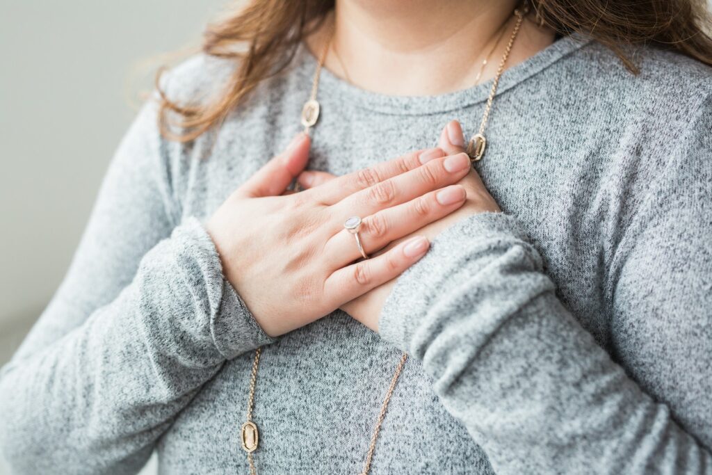 woman with her hands over her heart