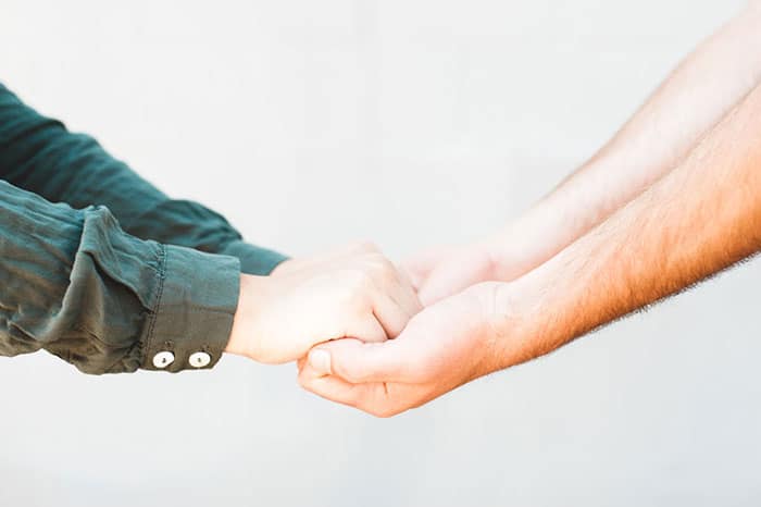 couple holding hands in relationship