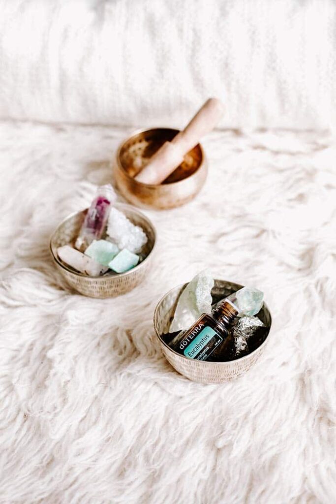 essential oils with crystals on a sheepskin rug