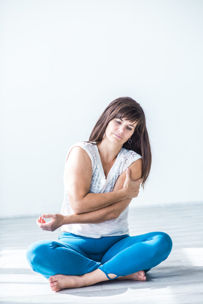 woman holding arm from pain