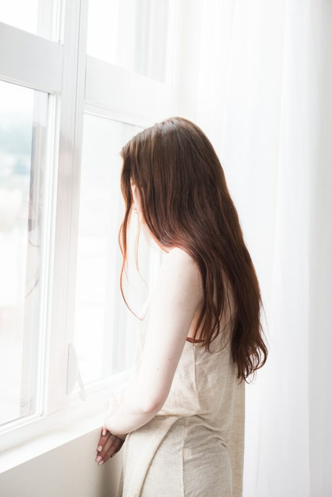 Girl looking out window