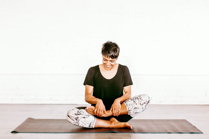 woman in black tshirt practicing yoga 