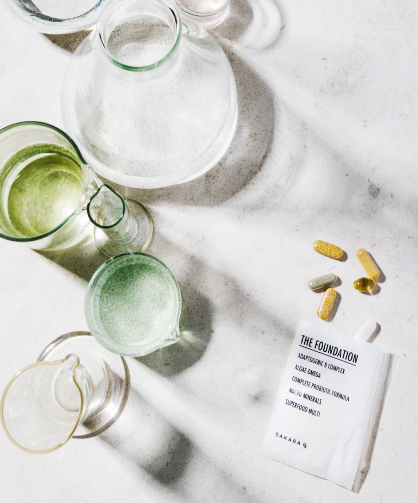 sakara supplement packet with glass vase