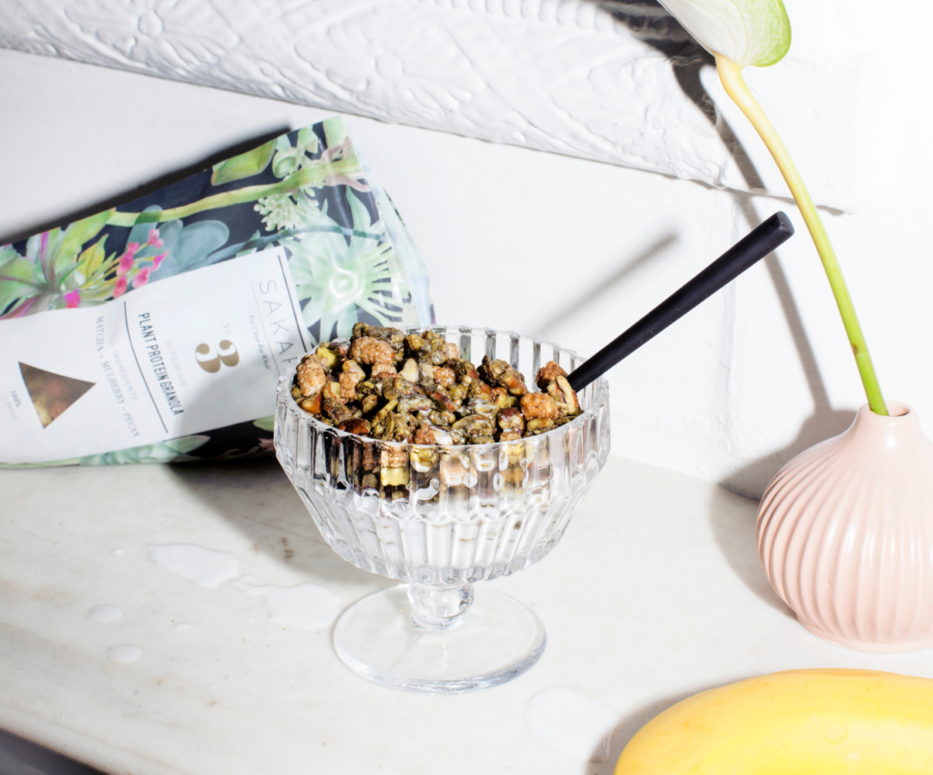 Sakara granola in a glass with milk