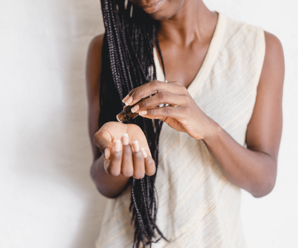 woman putting essential oils on her wrist